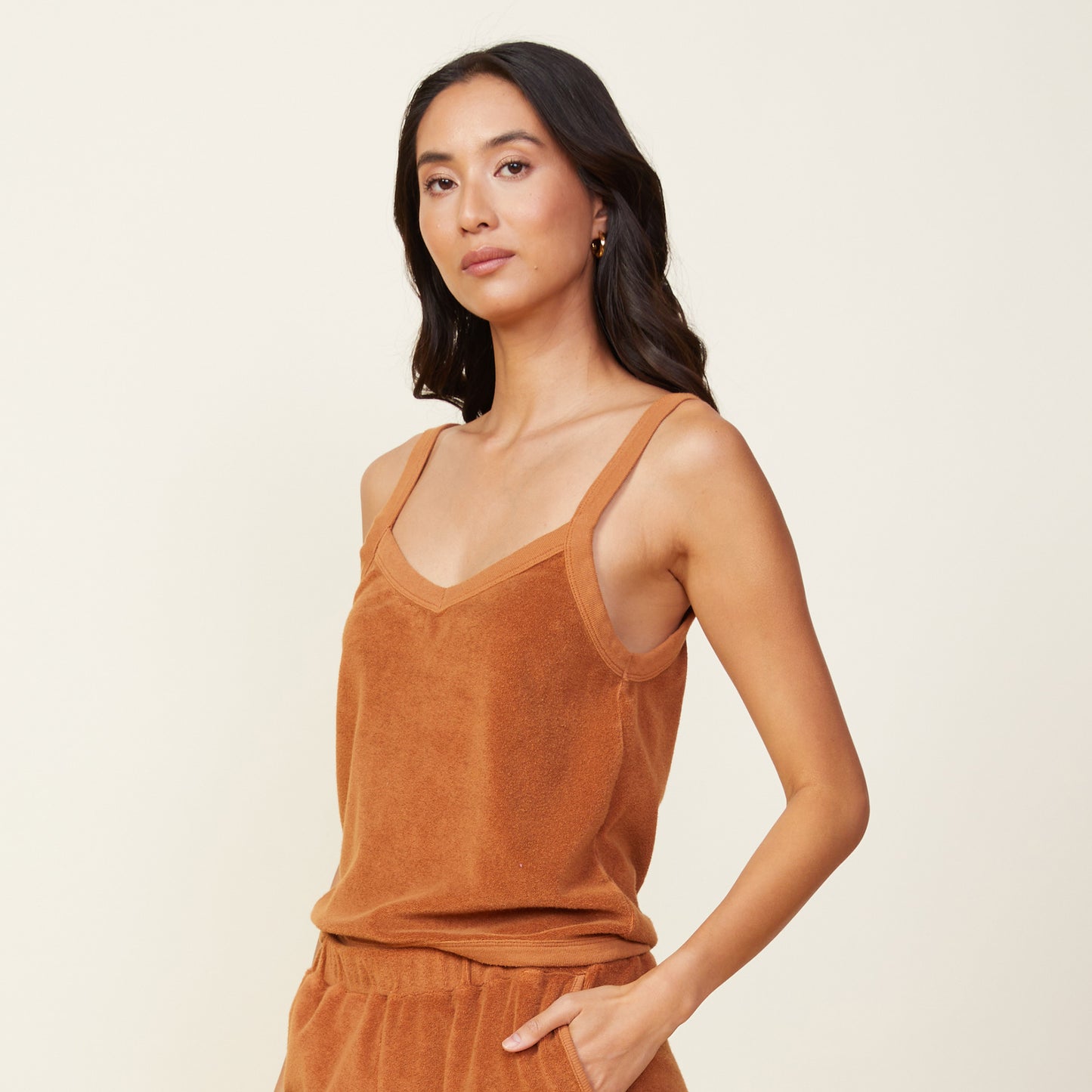 Side view of model wearing the terry cloth tank in coconut.