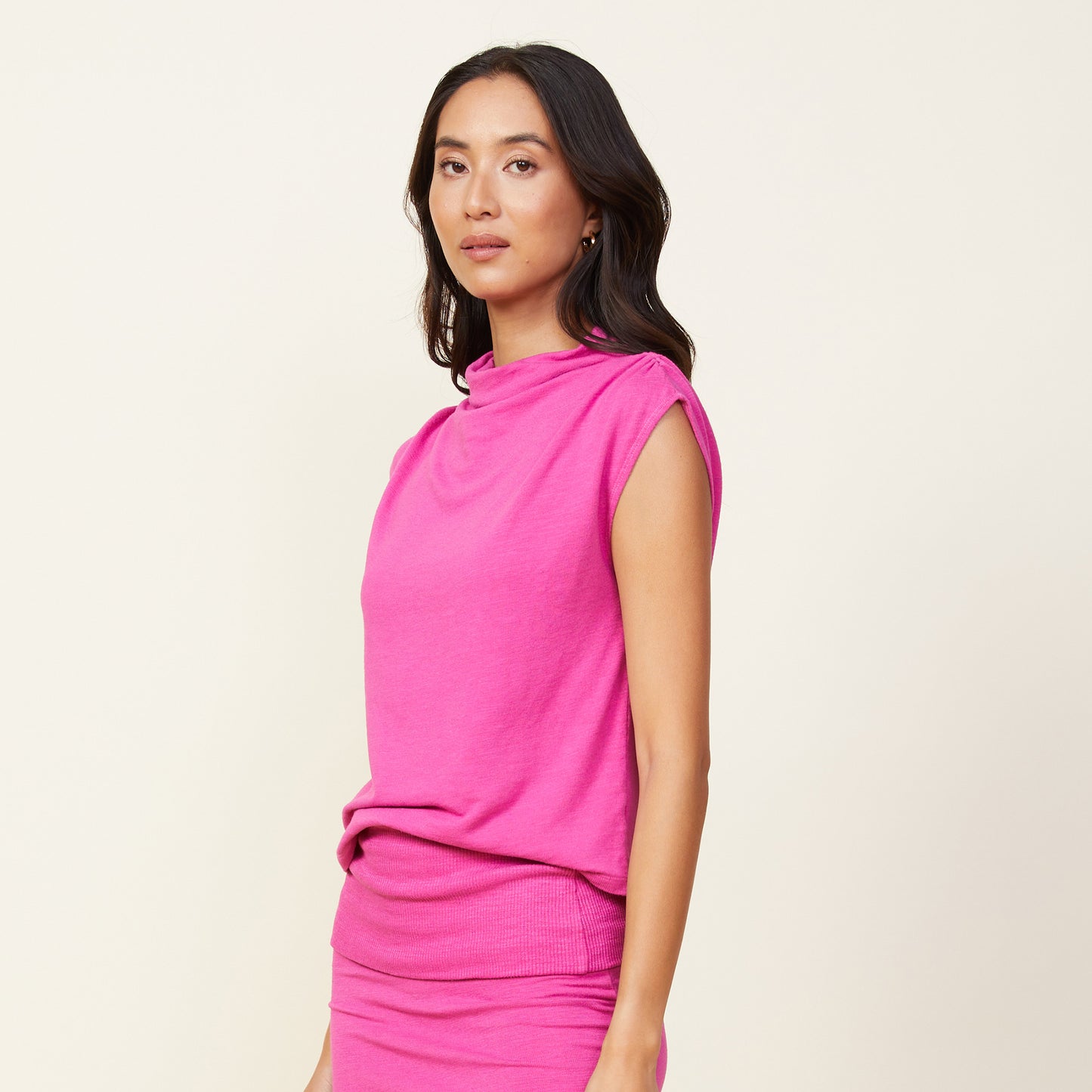 Side view of model wearing the supersoft shirred shoulder top in raspberry rose.