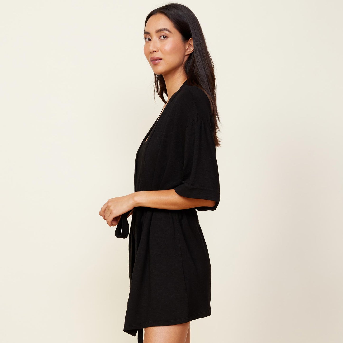 Side view of model wearing the supersoft robe in black.