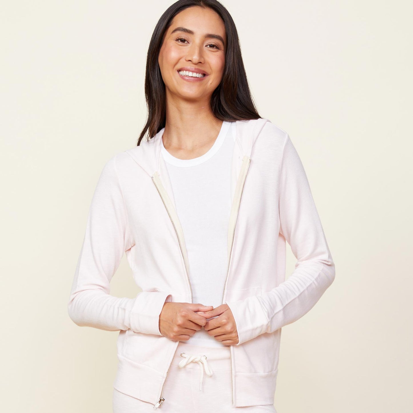Front view of model wearing the supersoft zip up hoody in peony.