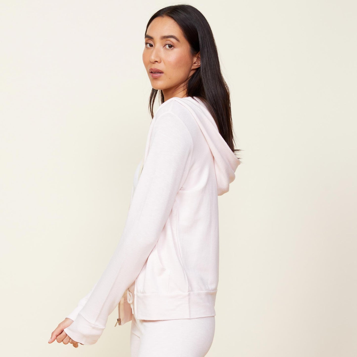 Side view of model wearing the supersoft zip up hoody in peony.