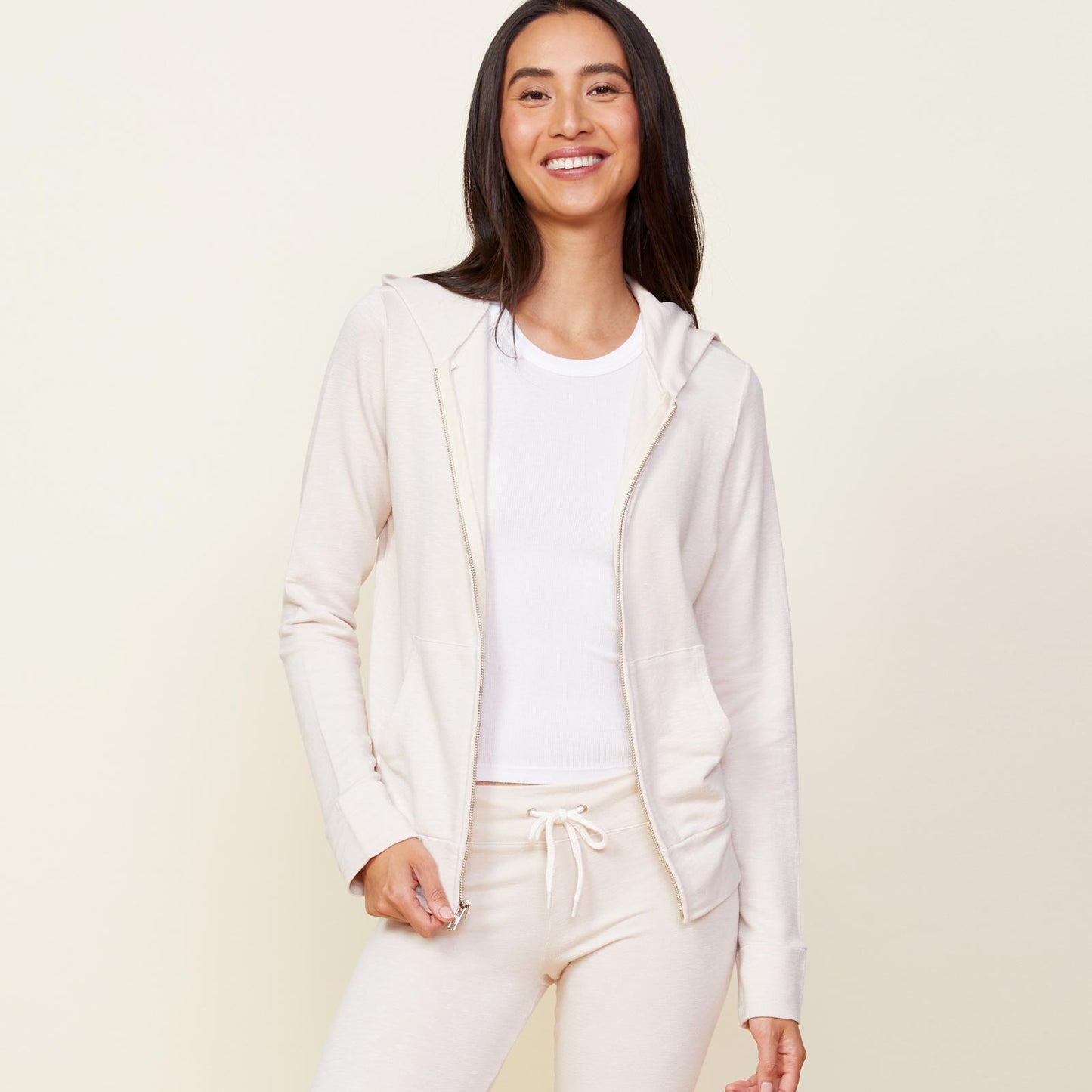 Front view of model wearing the supersoft zip up hoody in bone.