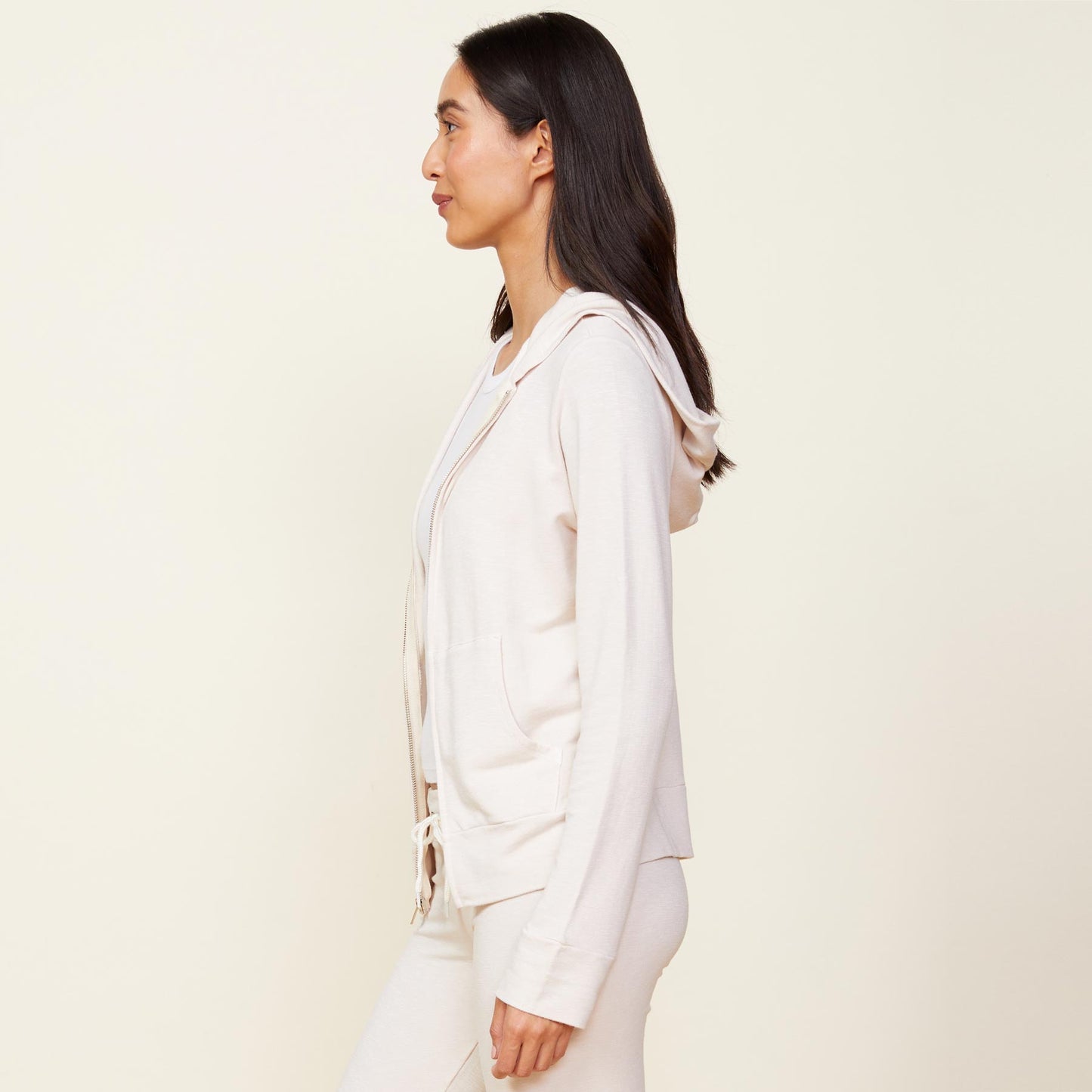 Side view of model wearing the supersoft zip up hoody in bone.