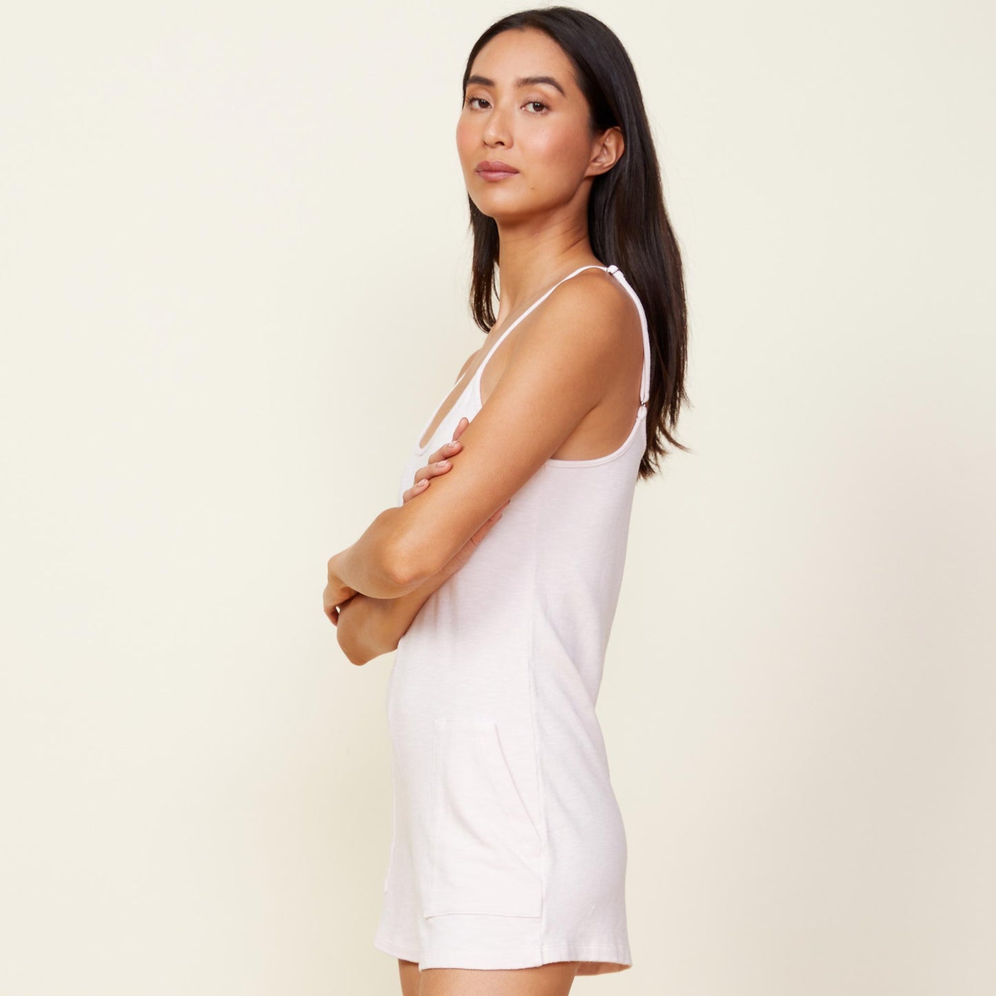 Side view of model wearing the supersoft easy romper in peony.