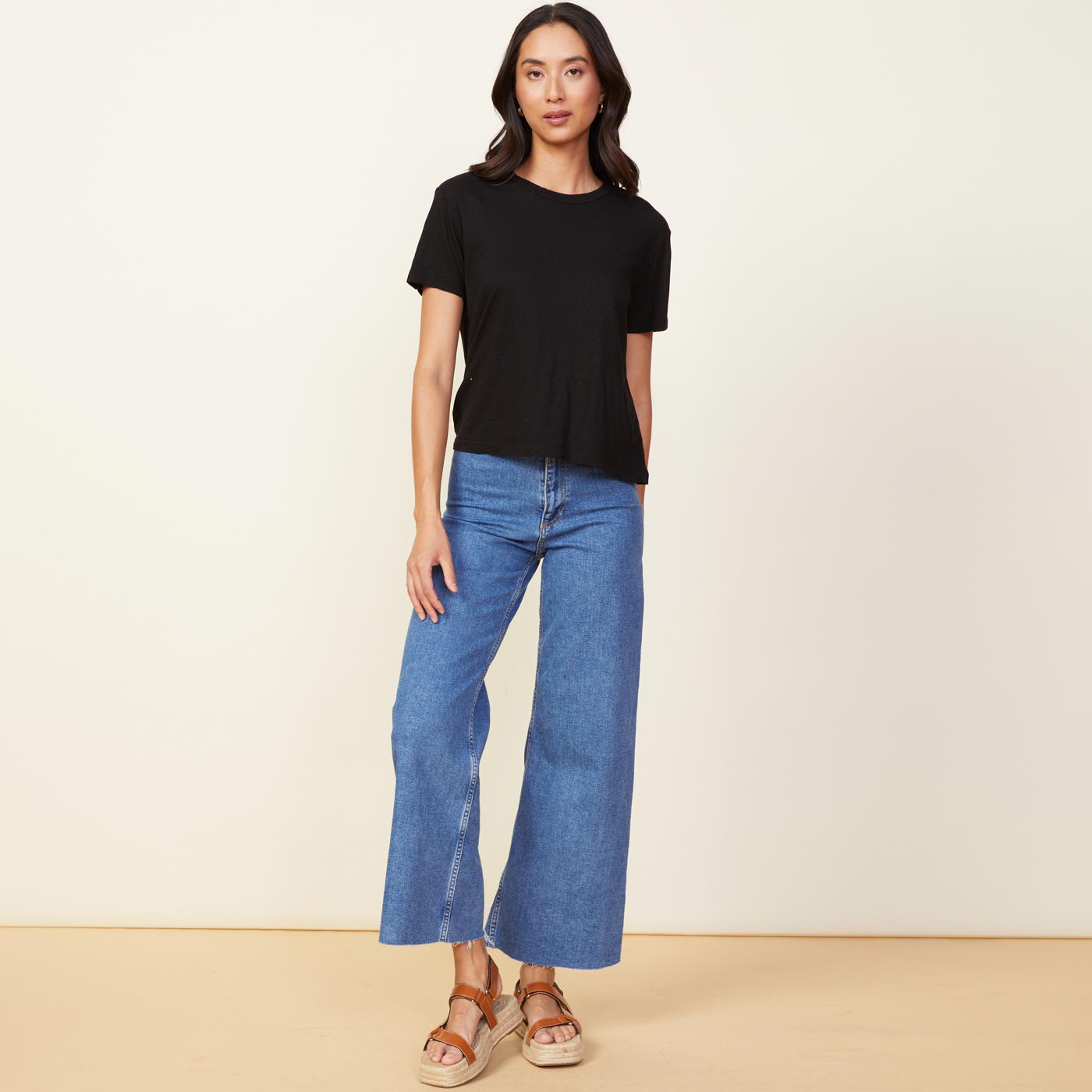 Front view of model wearing the linen athletic tee in black.