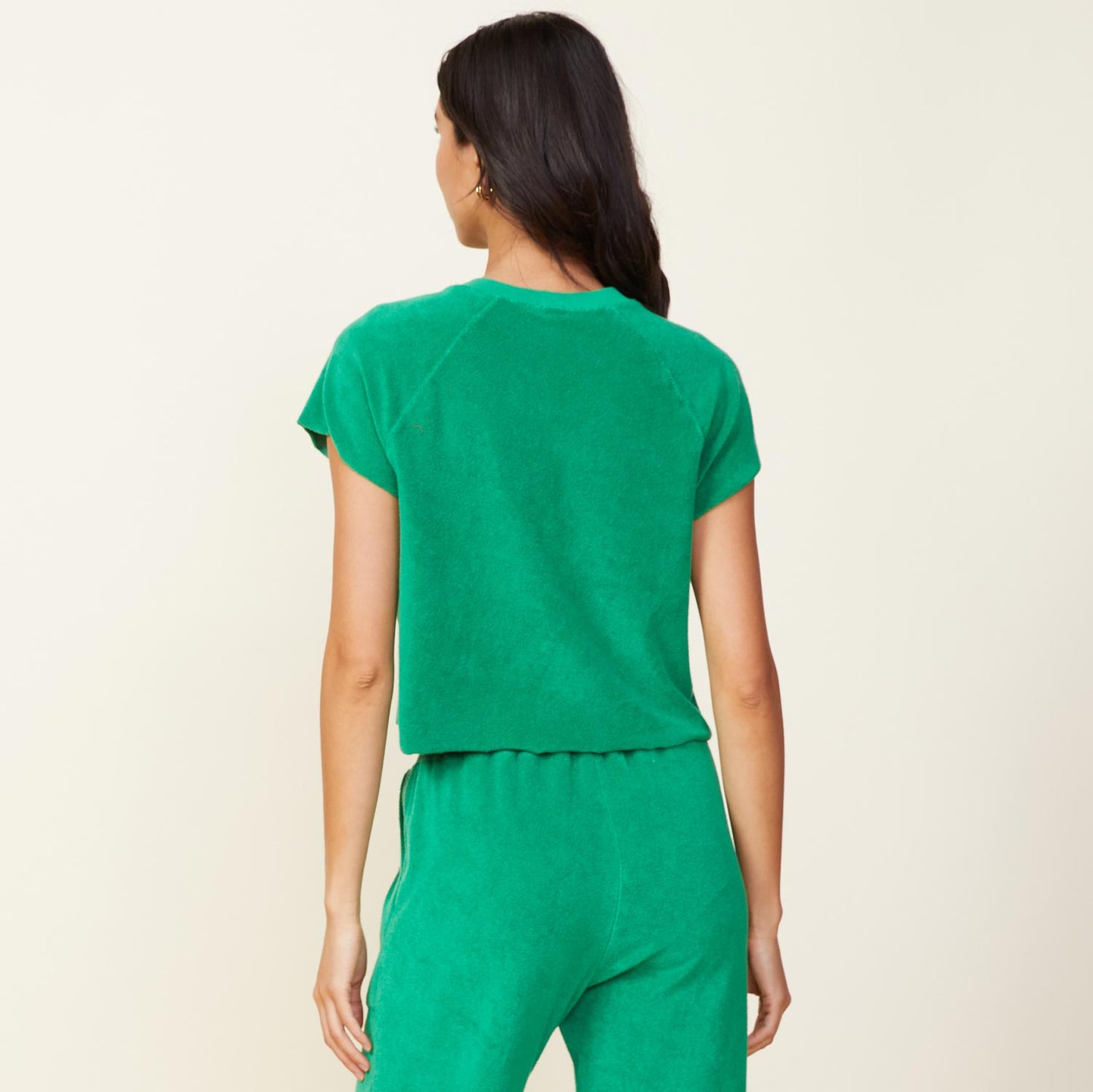 Back view of model wearing the terry cloth cut off raglan in jungle.