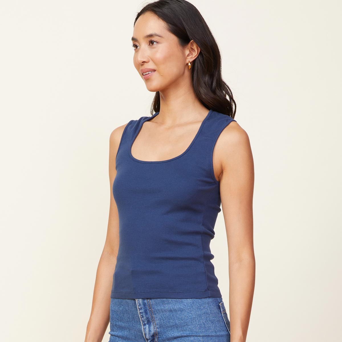 Side view of model wearing the 90's rib tank in dark denim.