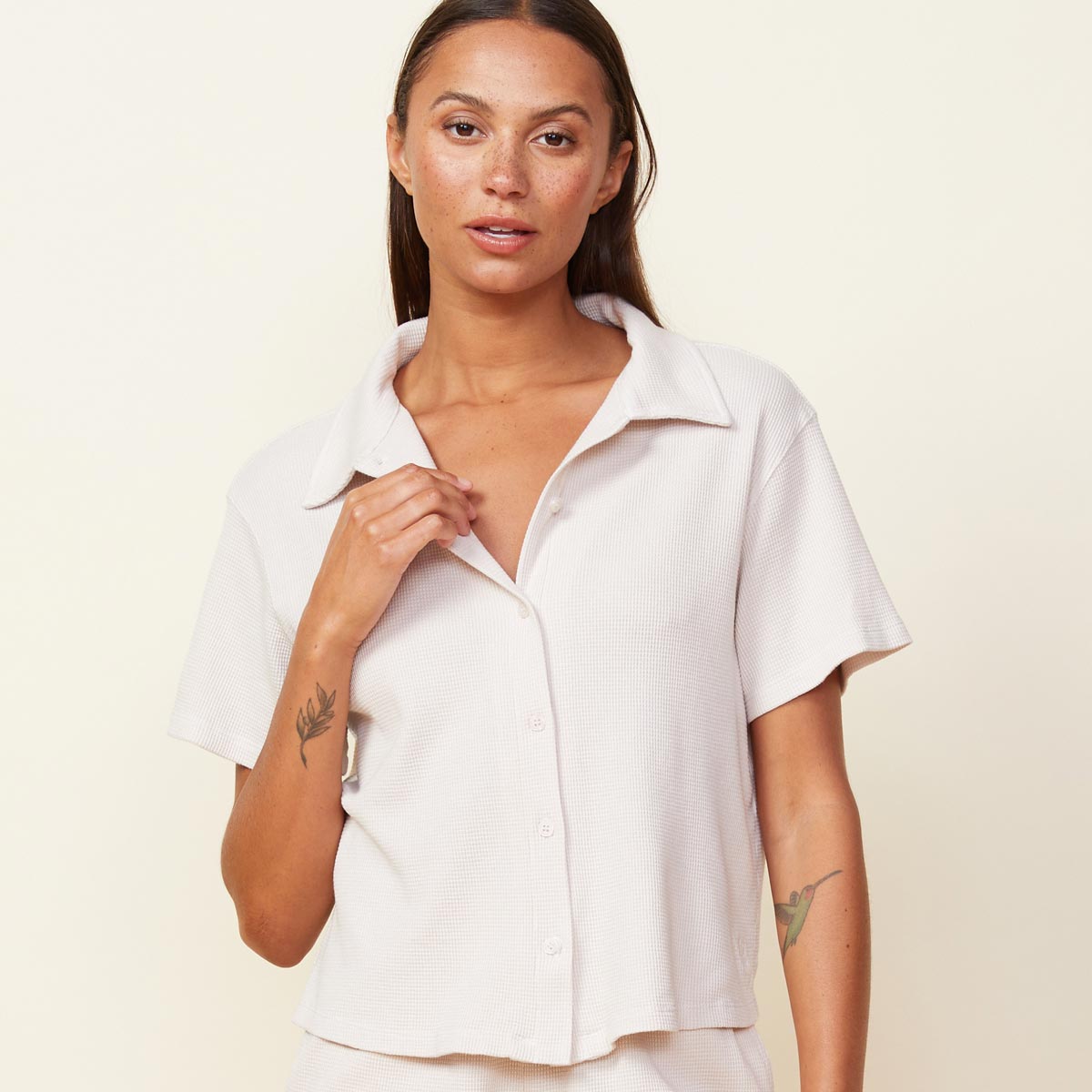 Front view of model wearing the baby thermal vacation shirt in bone.