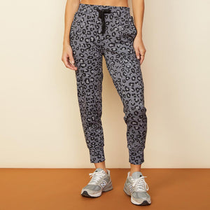 Front view of model wearing the leopard movement jogger in vintage black.