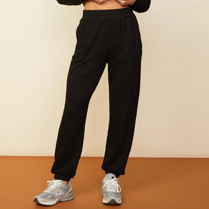 Front view of model wearing the baggy sweats in black