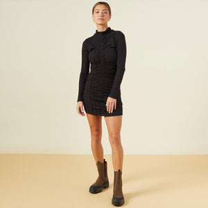 Front view of model wearing the flat rib mock shirred dress in black.