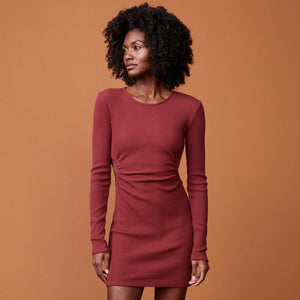 Front view of model wearing the brushed rib cut out dress in rhubarb.