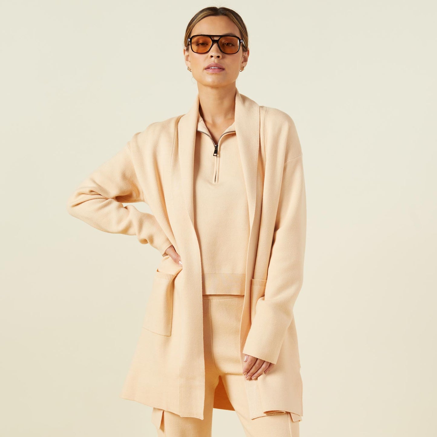 Front view of model wearing the supersoft sweater knit cardigan in vanilla.