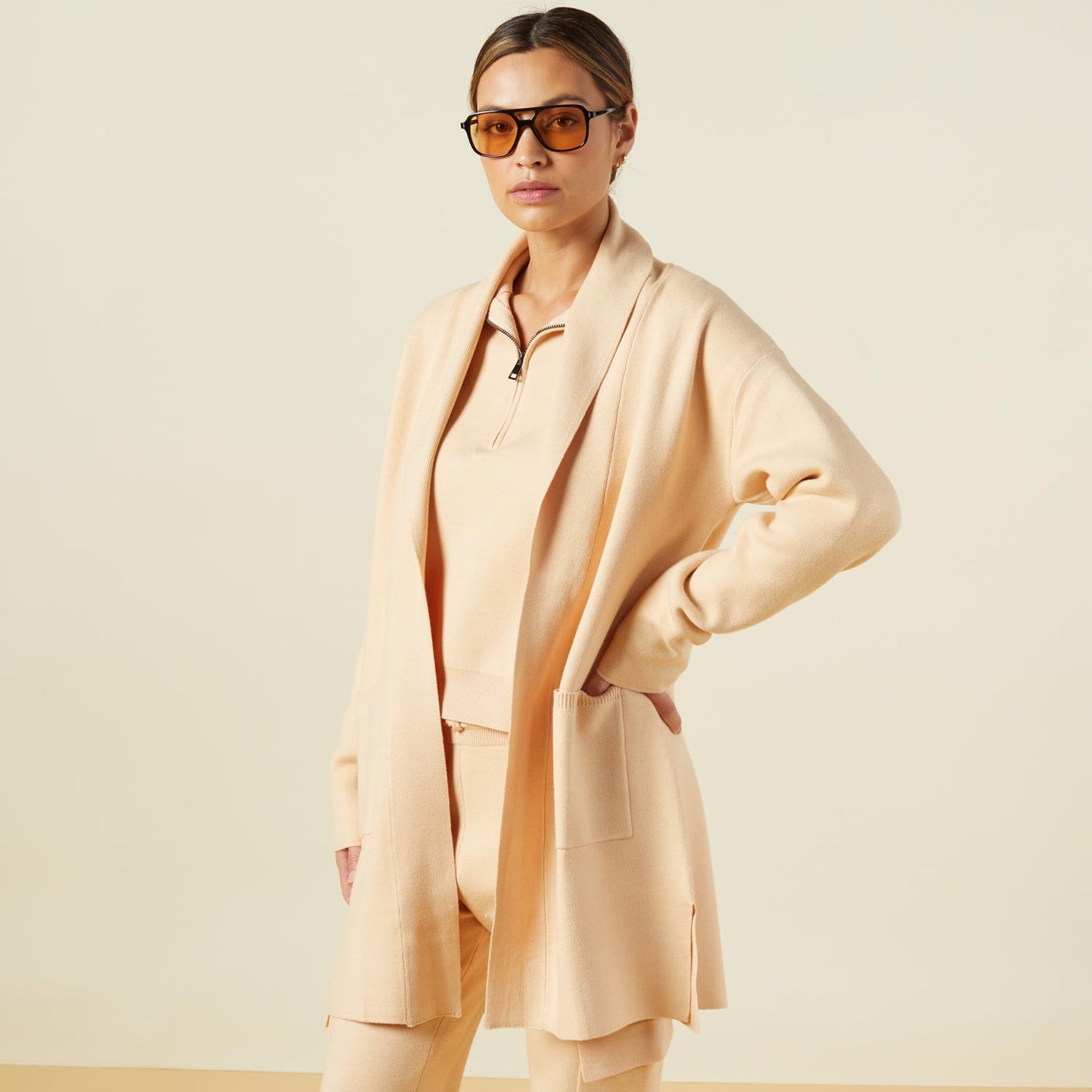 Side view of model wearing the supersoft sweater knit cardigan in vanilla.