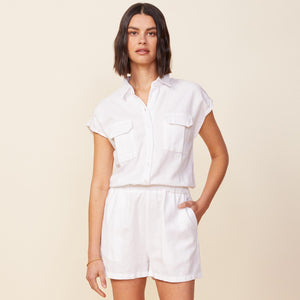 Front view of model wearing the cotton twill pocket romper in white.