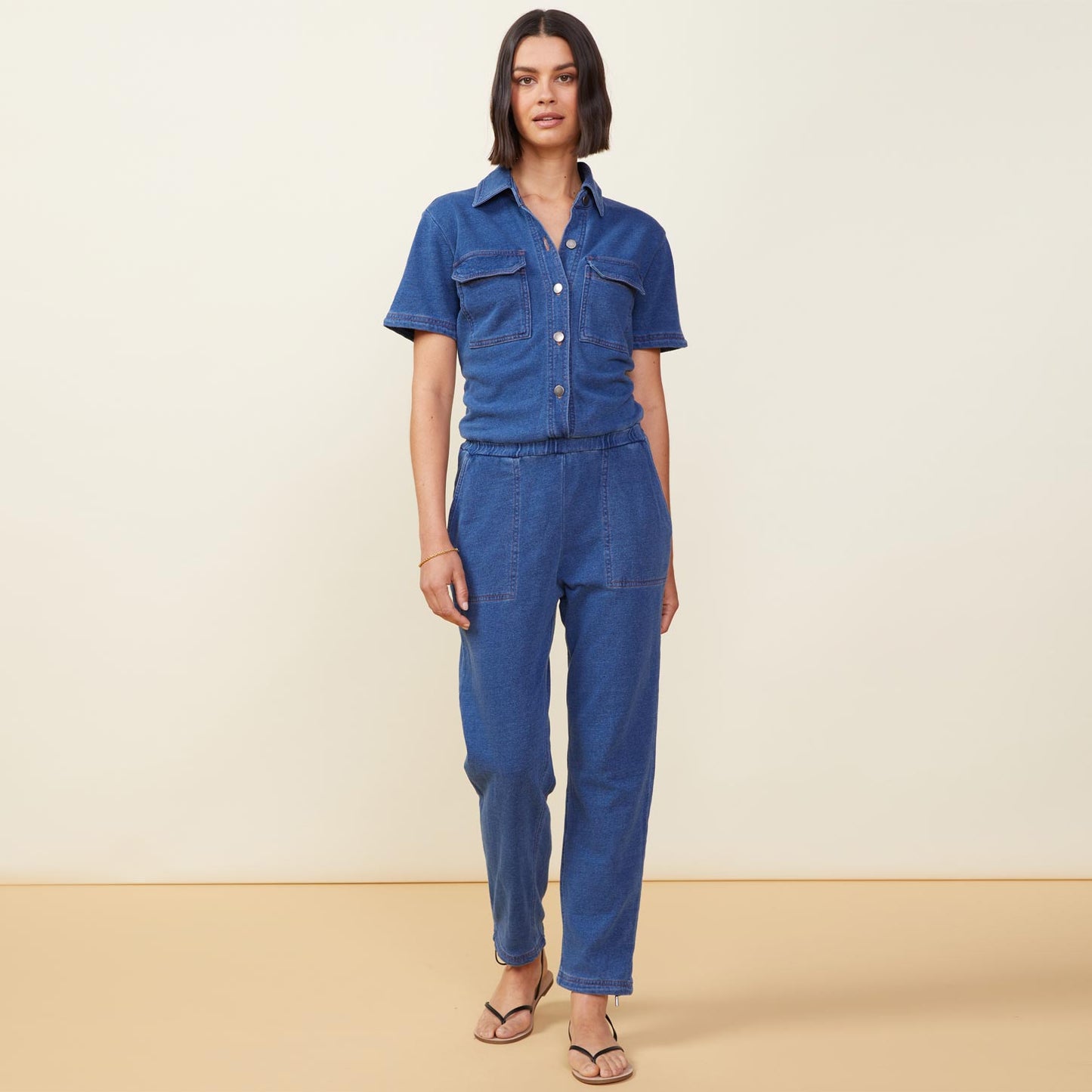 Front view of model wearing the indigo french terry jumpsuit in indigo.