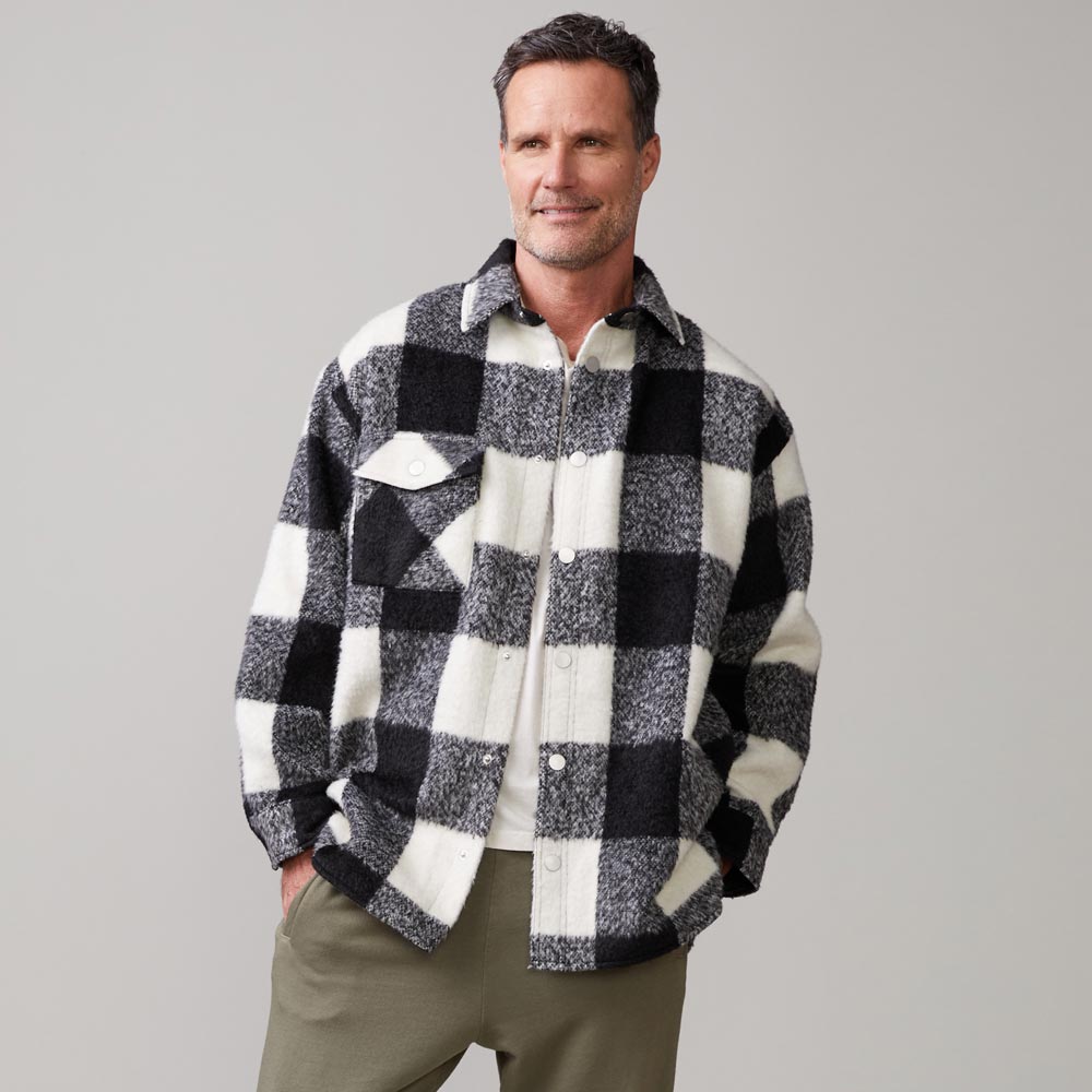 Front view of model wearing the plaid flannel jacket in black, natural check.