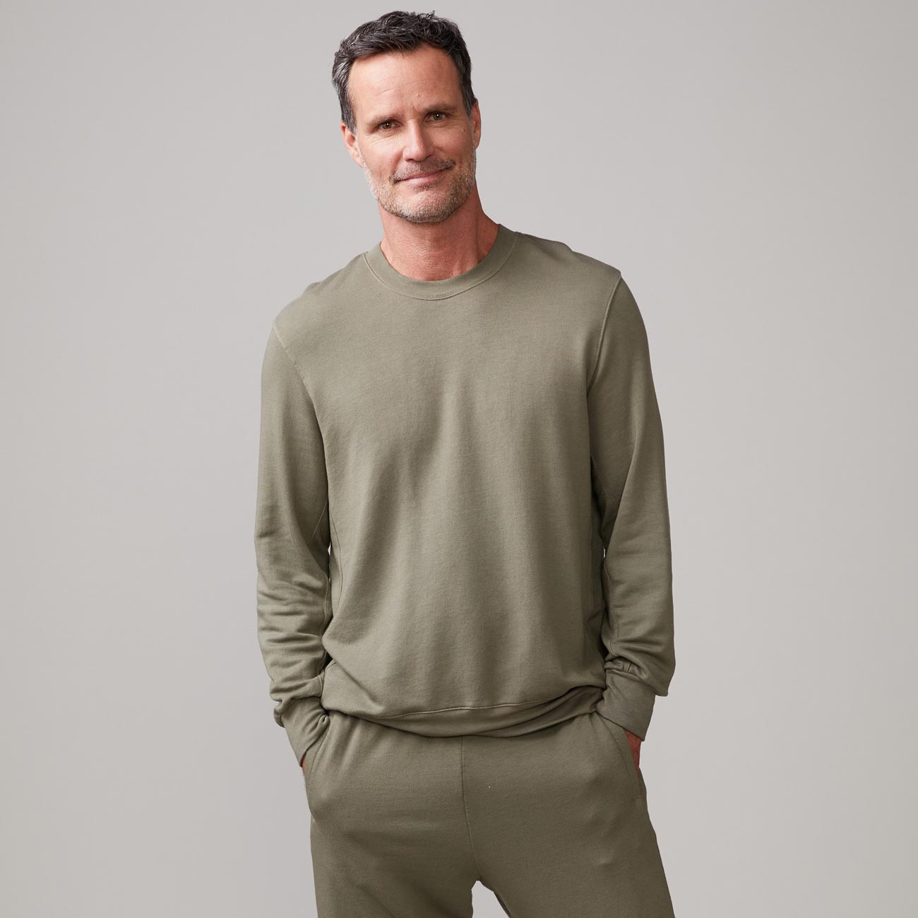 Front view of model wearing the lounge sweatshirt in army.