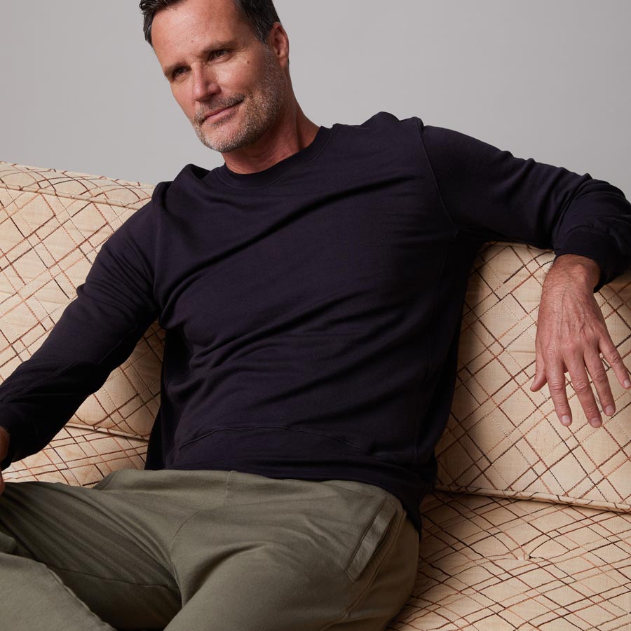 Front view of model wearing the lounge sweatshirt in faded black.