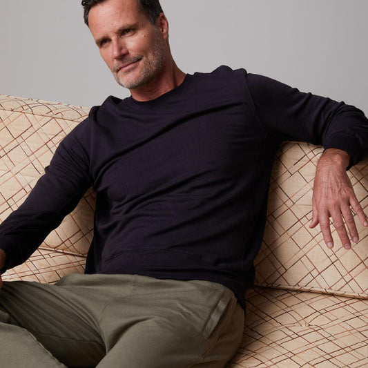 Front view of model wearing the lounge sweatshirt in faded black.