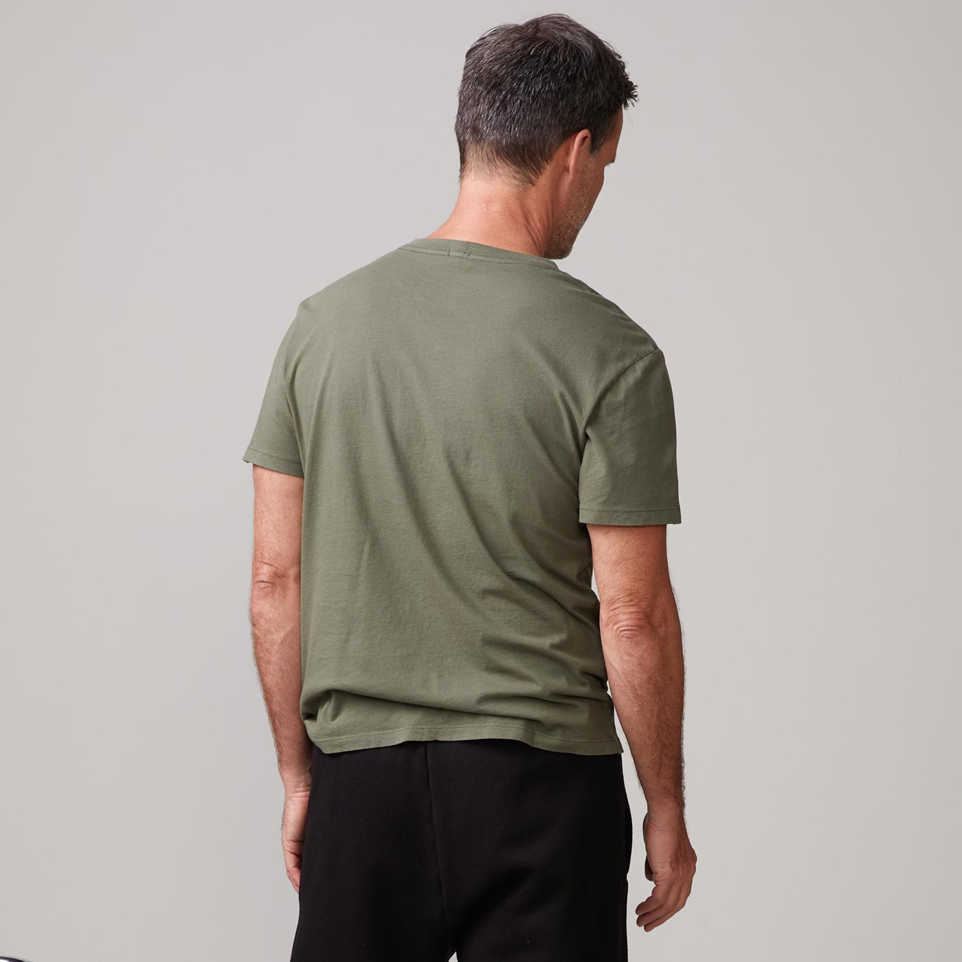 Back view of model wearing the relaxed crew in general green.