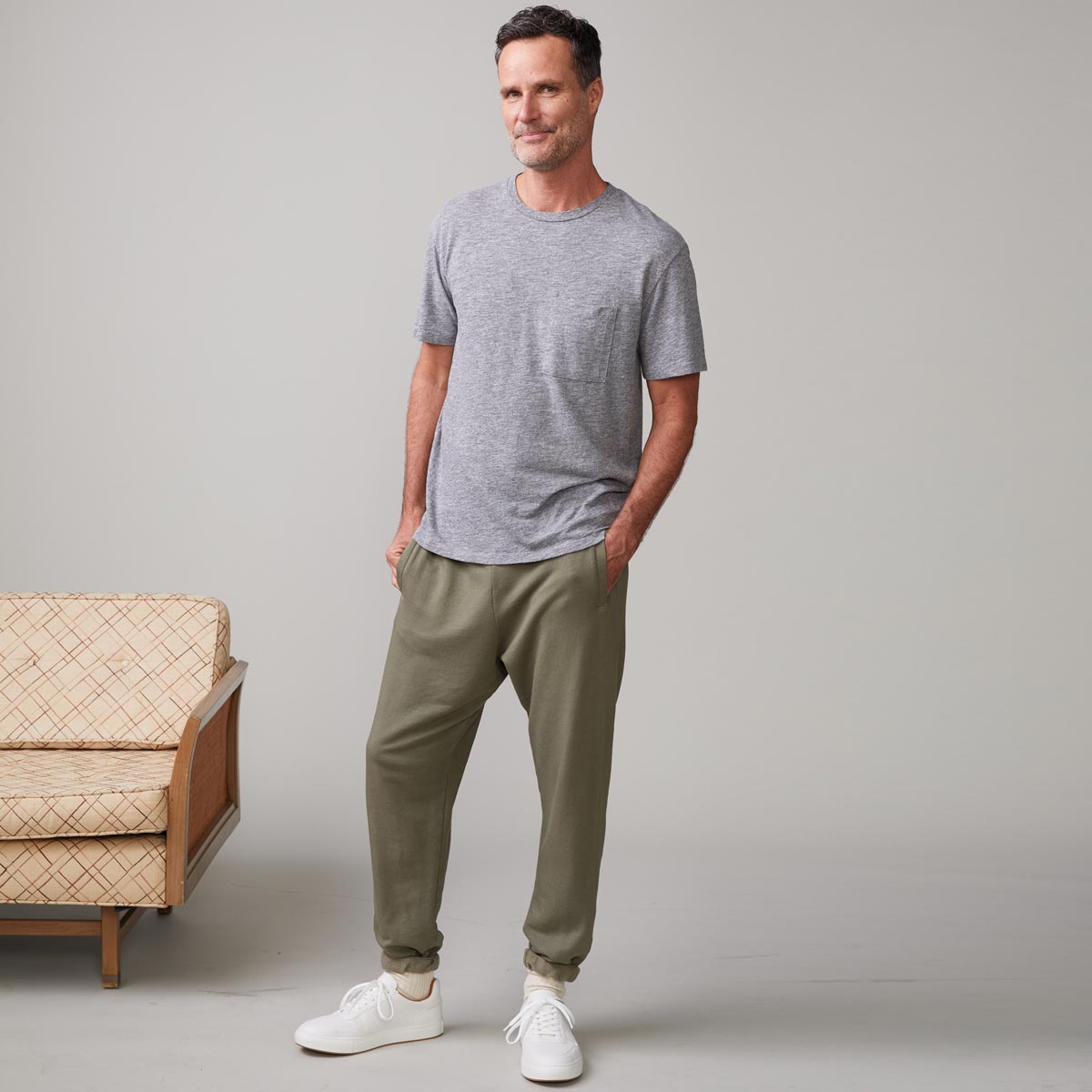 Front view of model wearing the textured tri-blend relaxed pocket crew in granite.