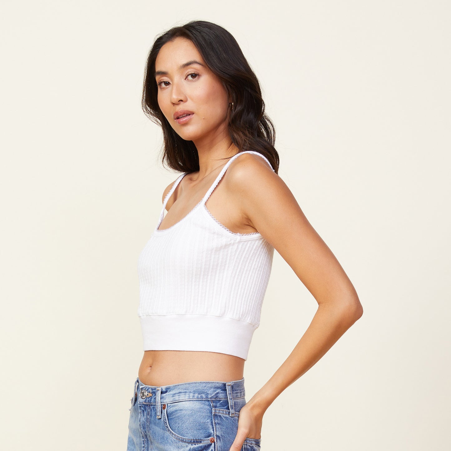 Side view of model wearing the cable rib mini tank in white.