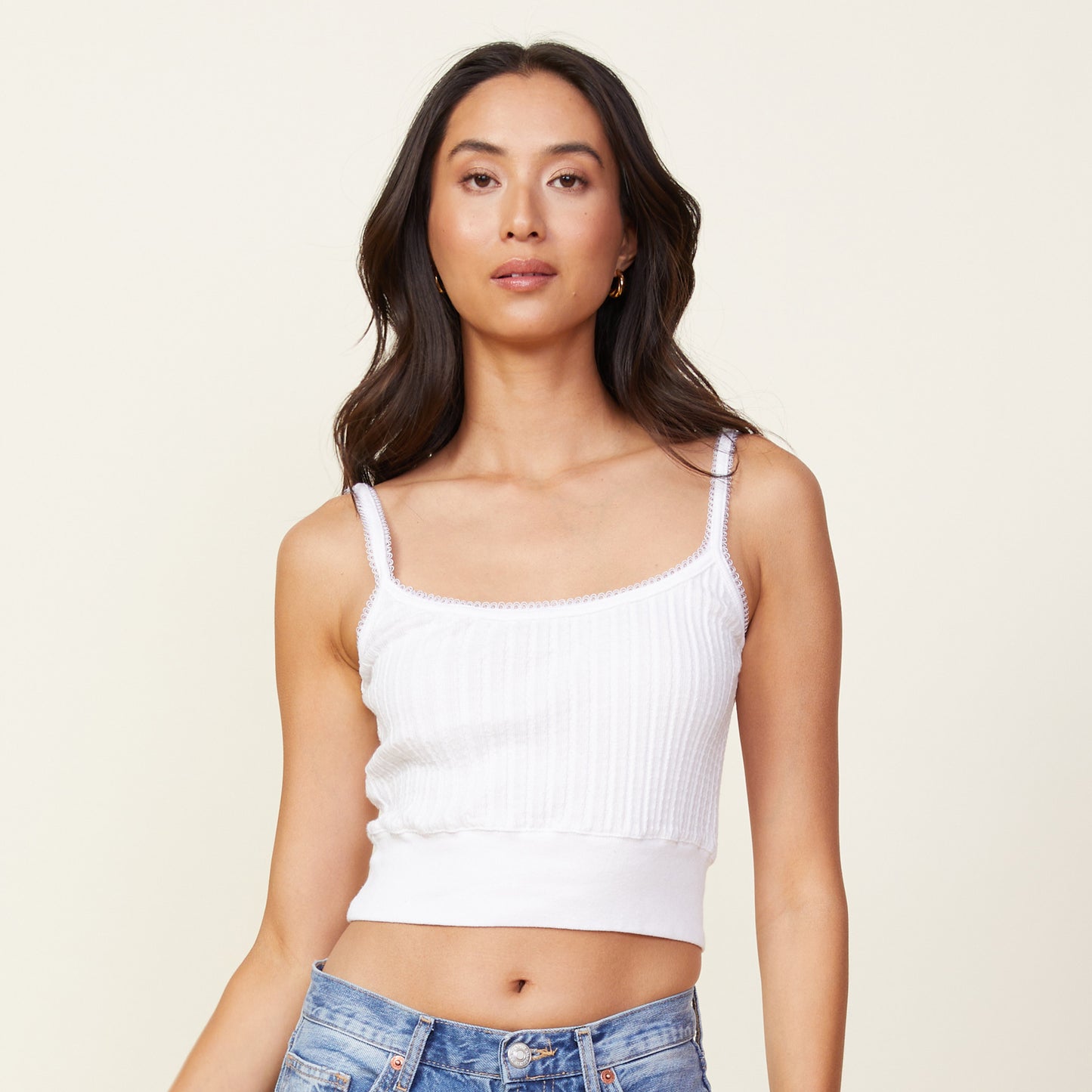 Front view of model wearing the cable rib mini tank in white.