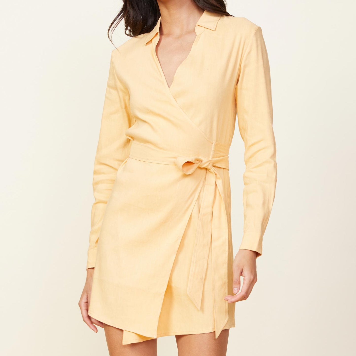 Front view of model wearing the linen mini dress in sand.