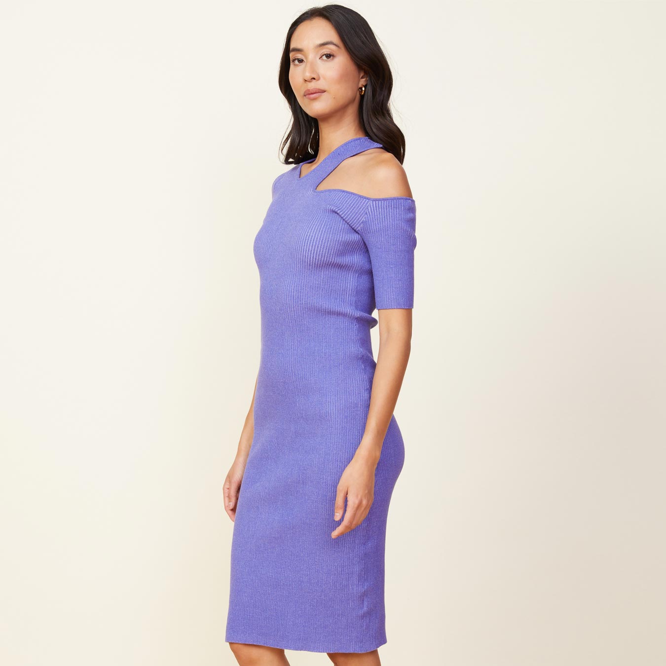 Side view of model wearing the sweater rib cut out dress in aster purple.
