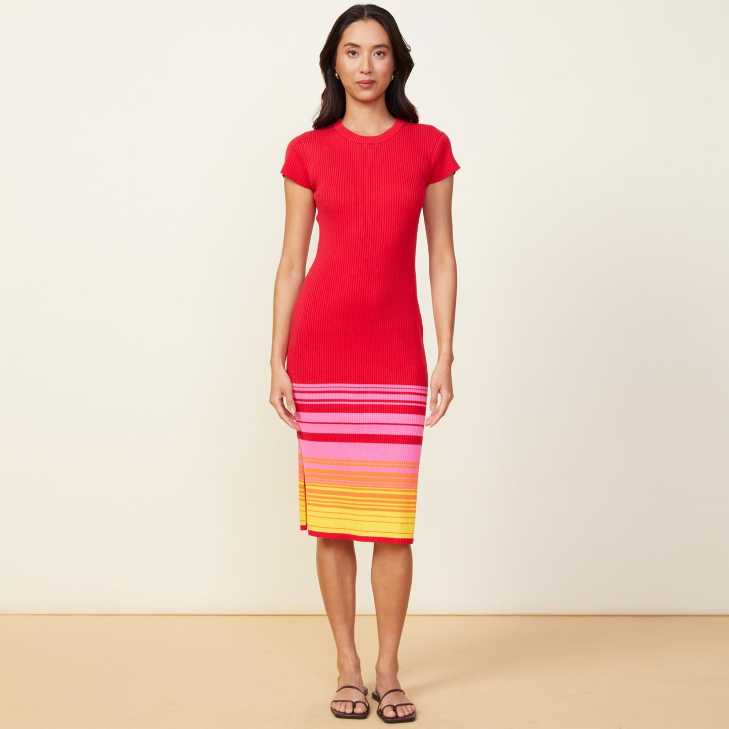 Front view of model wearing the sunset sweater cap sleeve midi dress in sunset.
