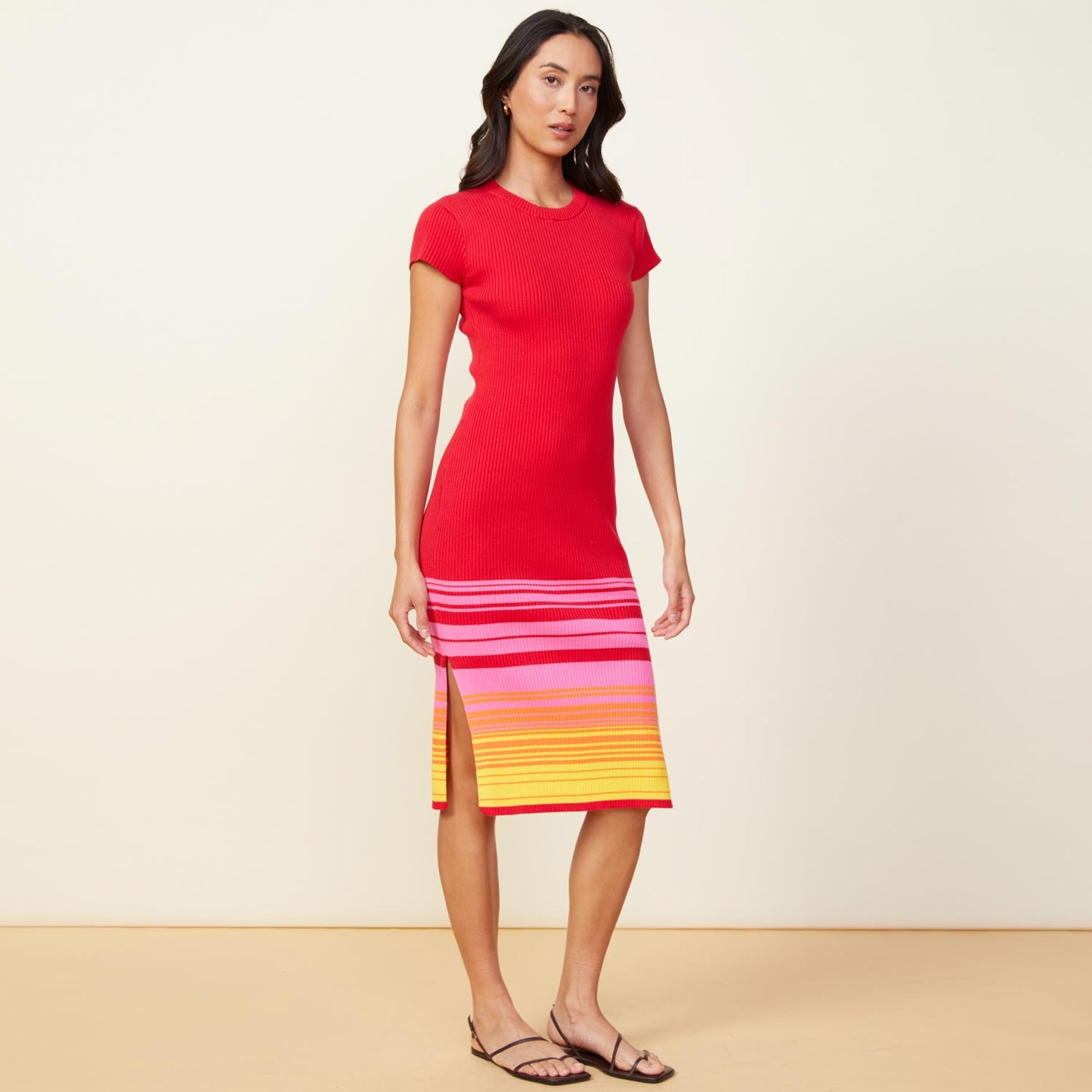 Front view of model wearing the sunset sweater cap sleeve midi dress in sunset.