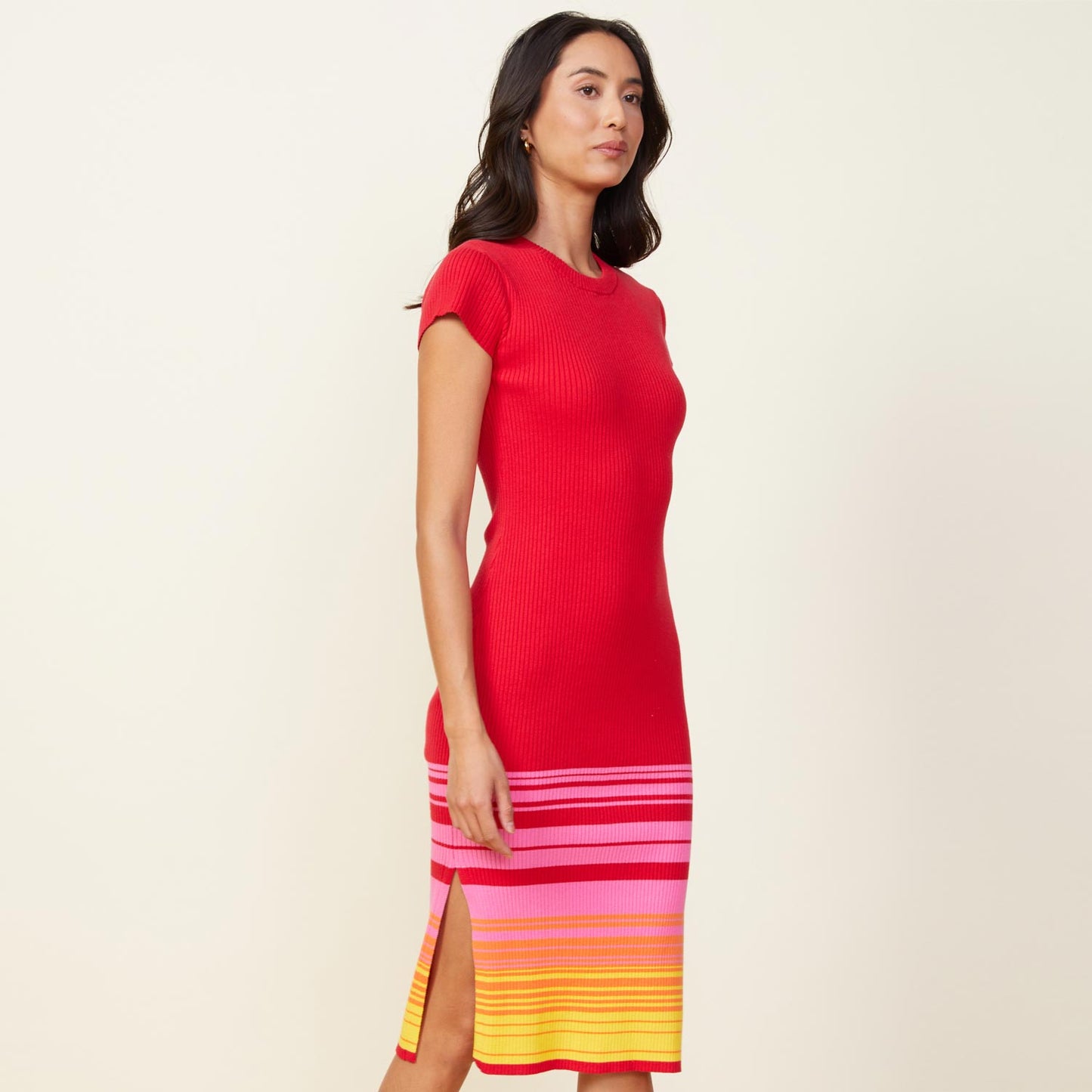 Side view of model wearing the sunset sweater cap sleeve midi dress in sunset.