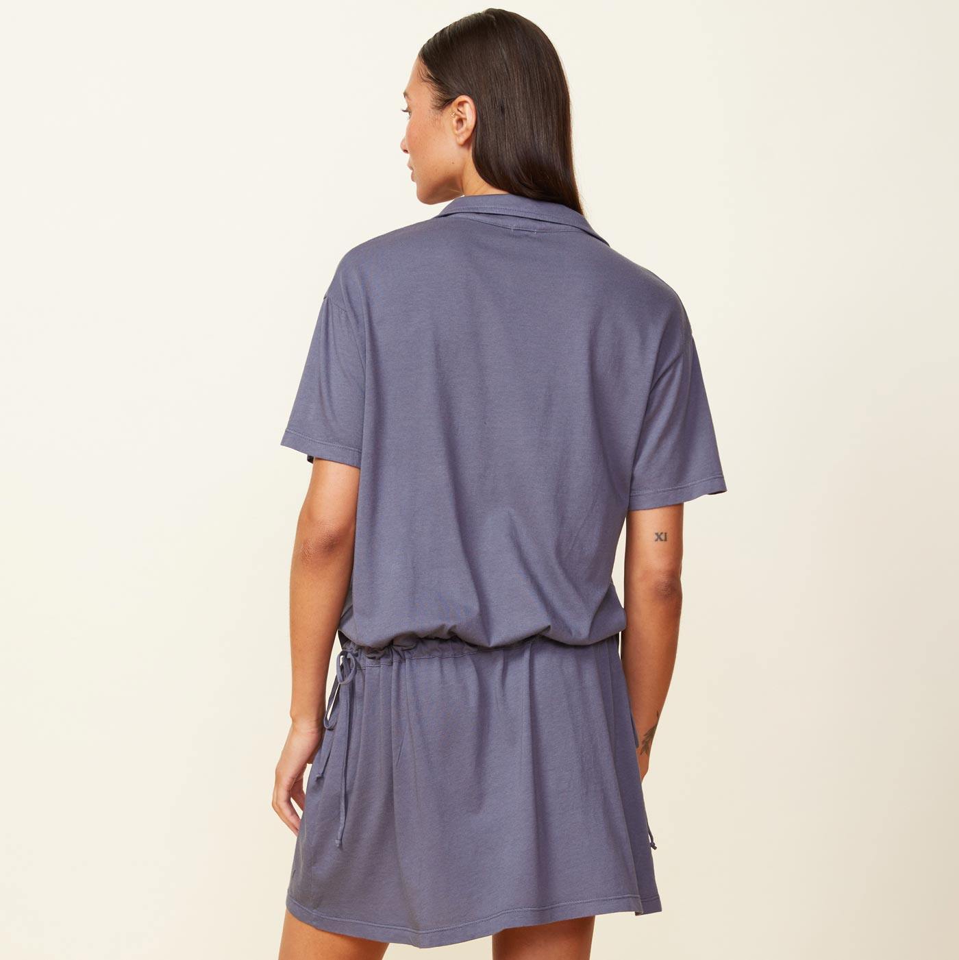 Back view of the model wearing the easy throw on dress in vintage black.
