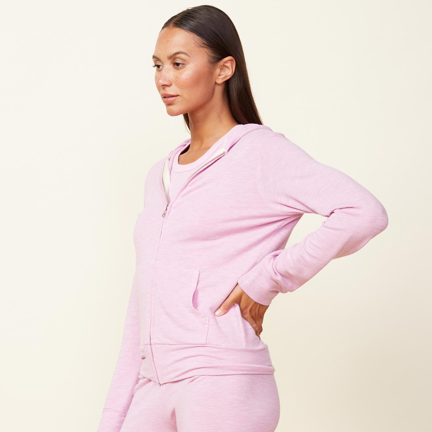 Side view of model wearing the supersoft zip up hoody in pink lavender.