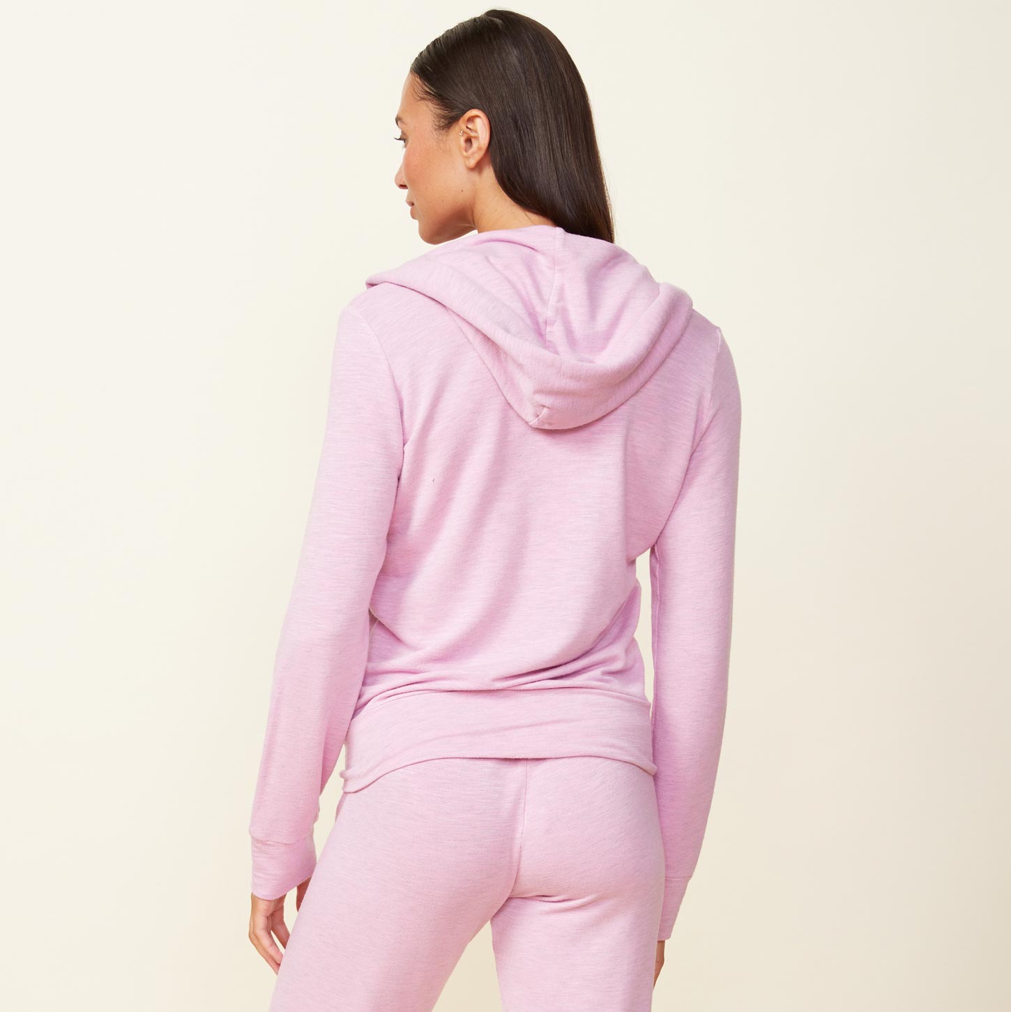 Back view of model wearing the supersoft zip up hoody in pink lavender.