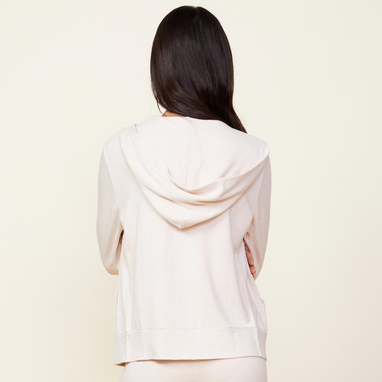 Back view of model wearing the supersoft zip up hoody in bone.
