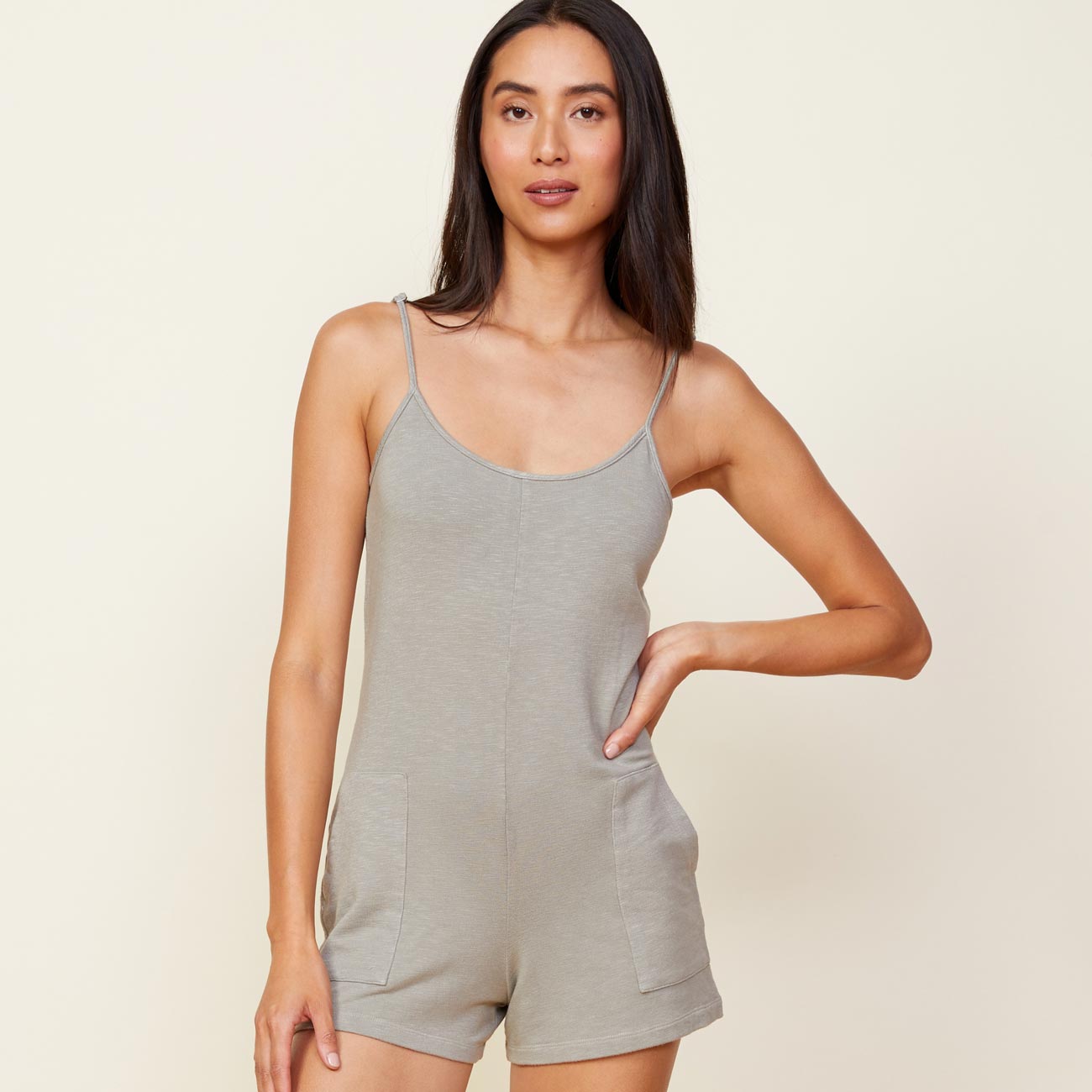 Front view of model wearing the supersoft easy romper in green tea.