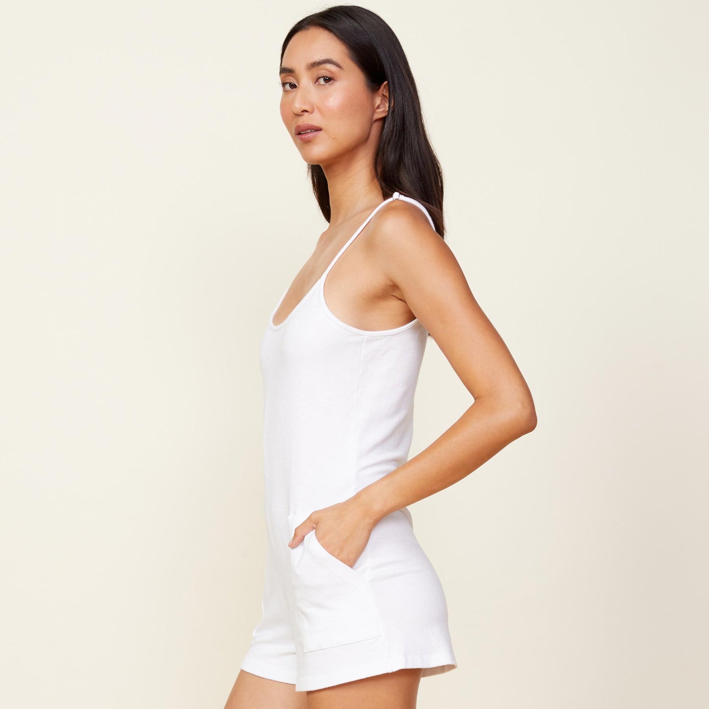 Side view of model wearing the supersoft easy romper in white.