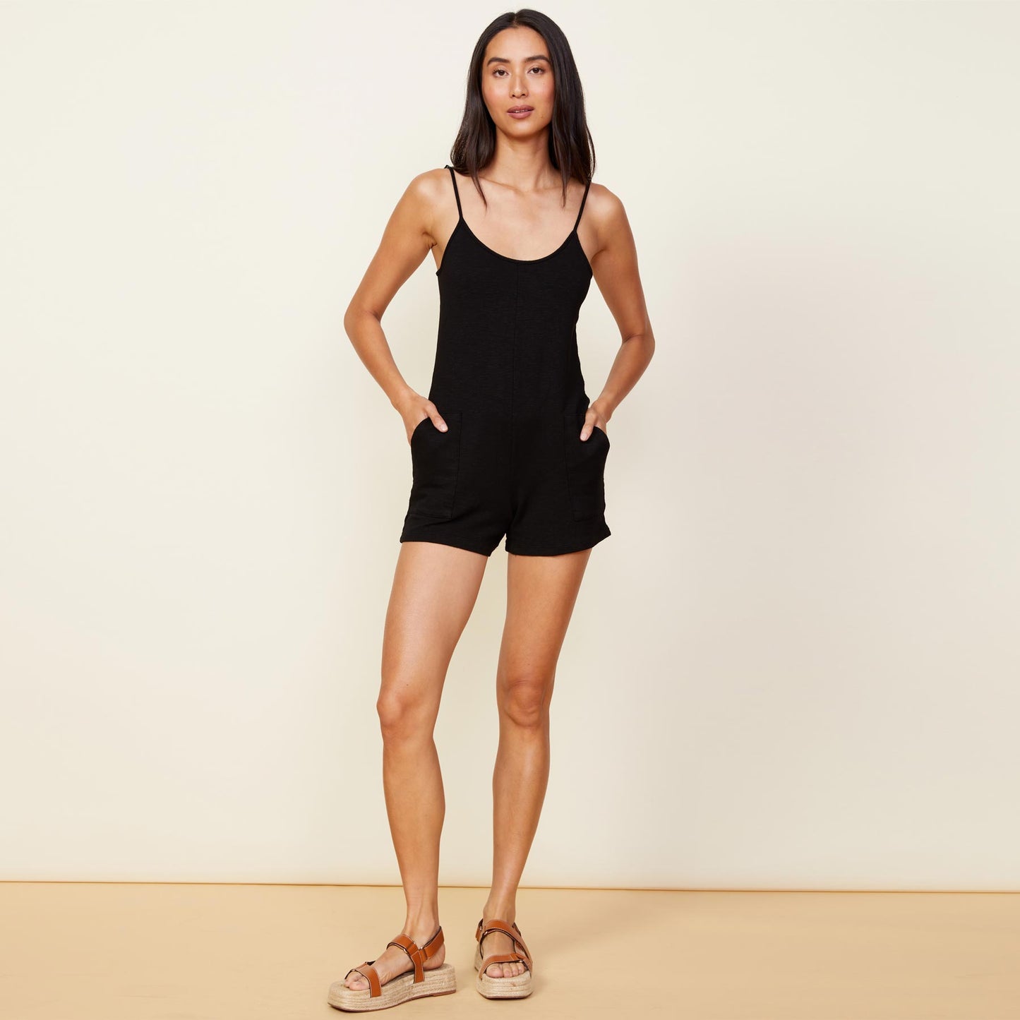 Front view of model wearing the supersoft easy romper in black.