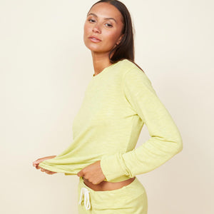 Close up view of model wearing the supersoft crew neck sweatshirt in citron.