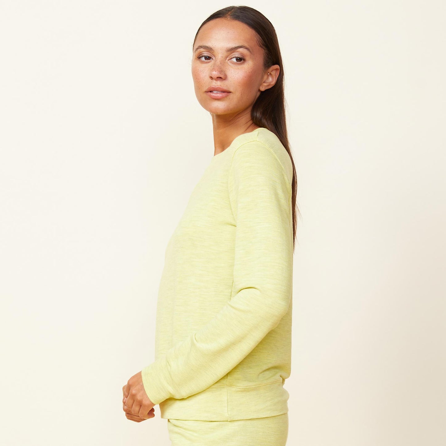 Side view of model wearing the supersoft crew neck sweatshirt in citron.