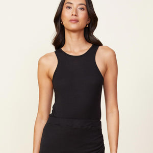 Front view of model wearing the light racer tank in black.