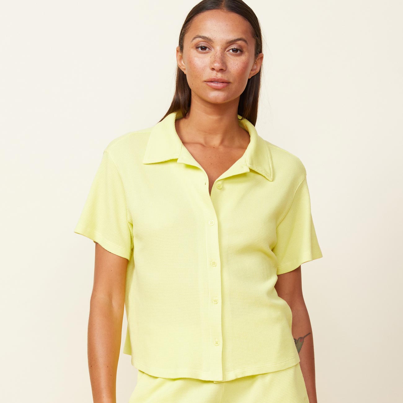 Front view of model wearing the baby thermal vacation shirt in citron.