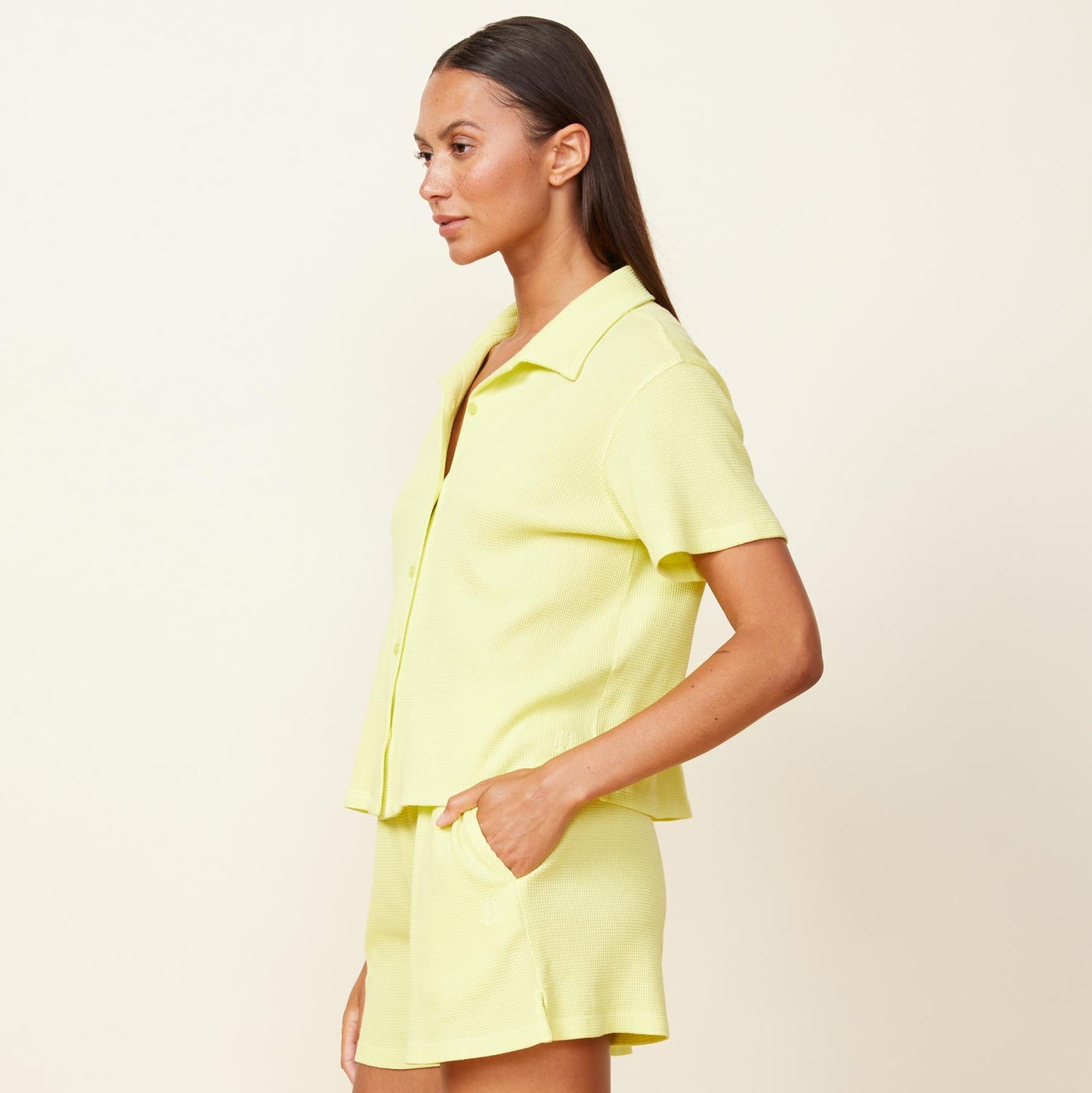 Side view of model wearing the baby thermal vacation shirt in citron.