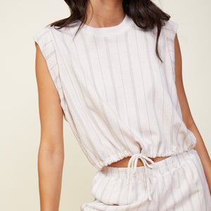 Close up view of model wearing the stripe drawstring sleeveless top in bone.