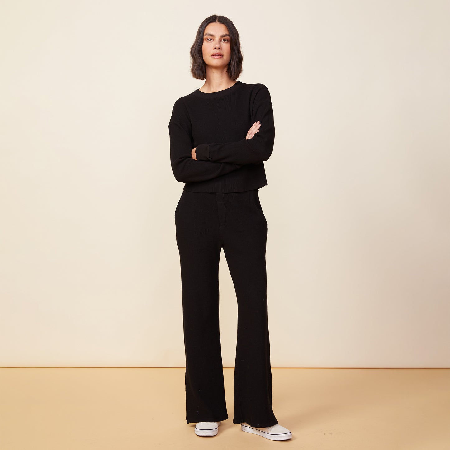 Front view of model wearing the thermal top in black.