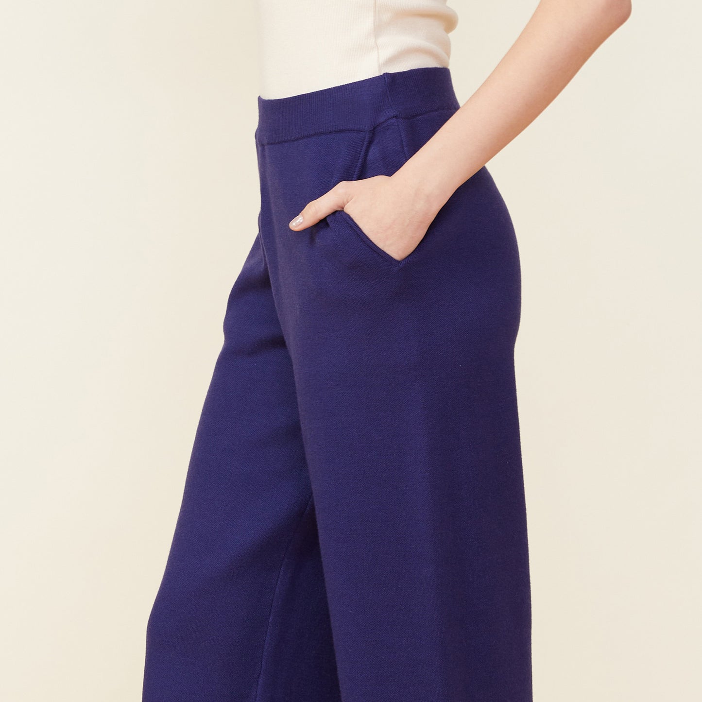 Close up view of model wearing the supersoft sweater knit slit pants in navy.
