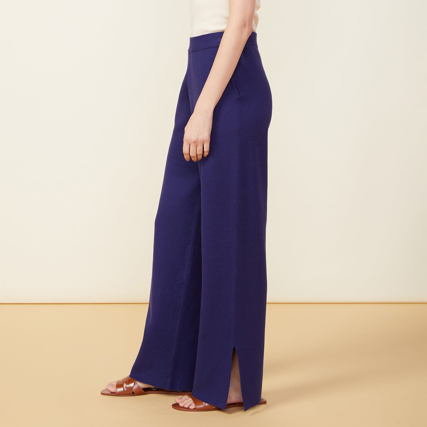 Side view of model wearing the supersoft sweater knit slit pants in navy.