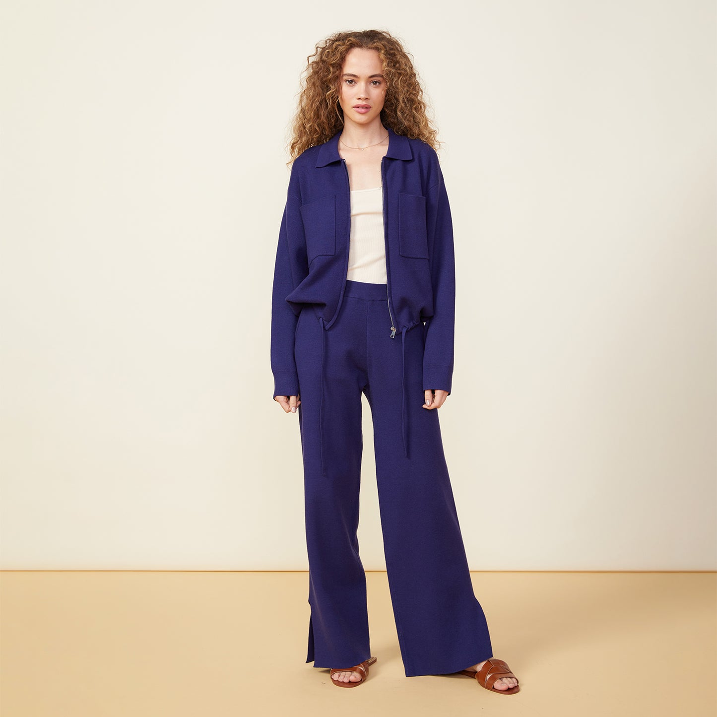 Front view of model wearing the supersoft sweater knit slit pants in navy.